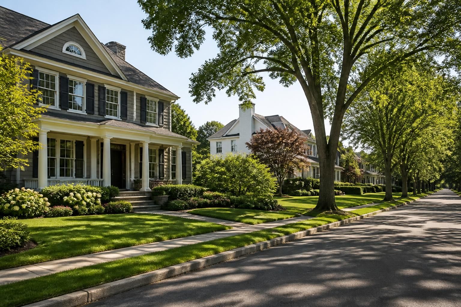 Upscale residential neighborhood with mature trees and spacious lawns.